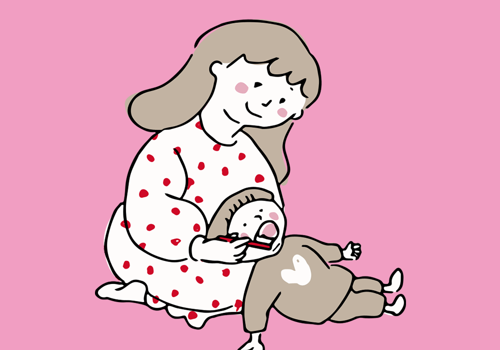 仕上げ磨きをする親子